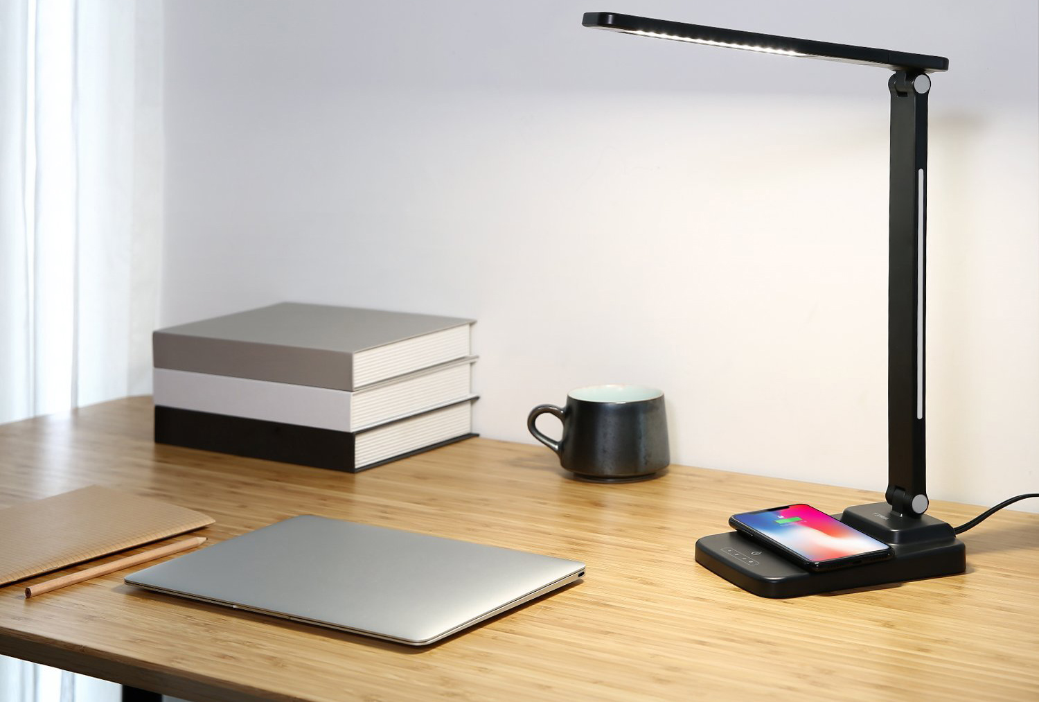Aukey’s LED desk lamp has a built-in wireless charger, and it’s