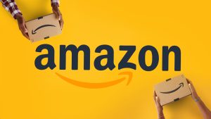 Amazon's logo on a yellow background with two people holding Amazon shipping boxes
