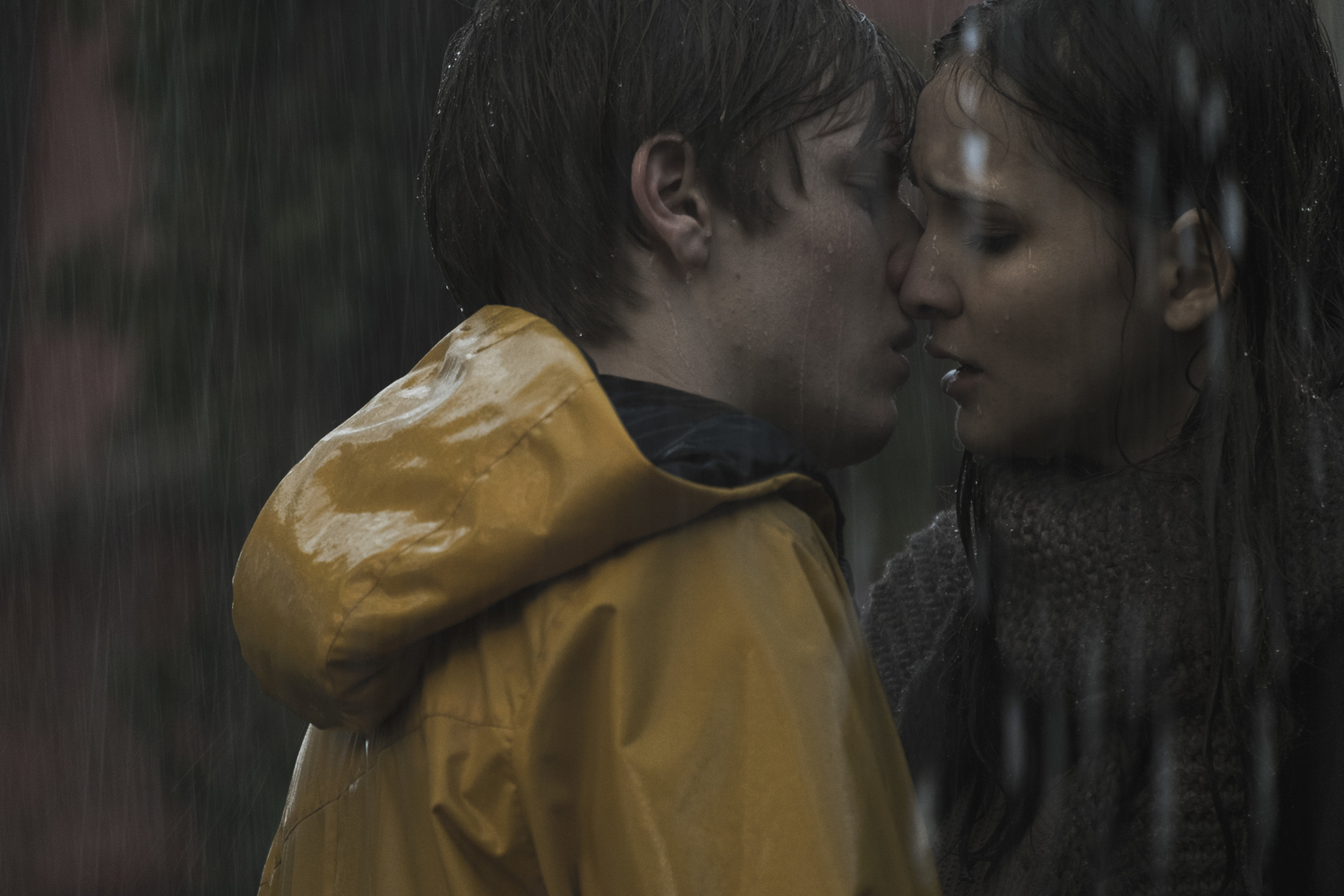 a boy shown kissing a girl