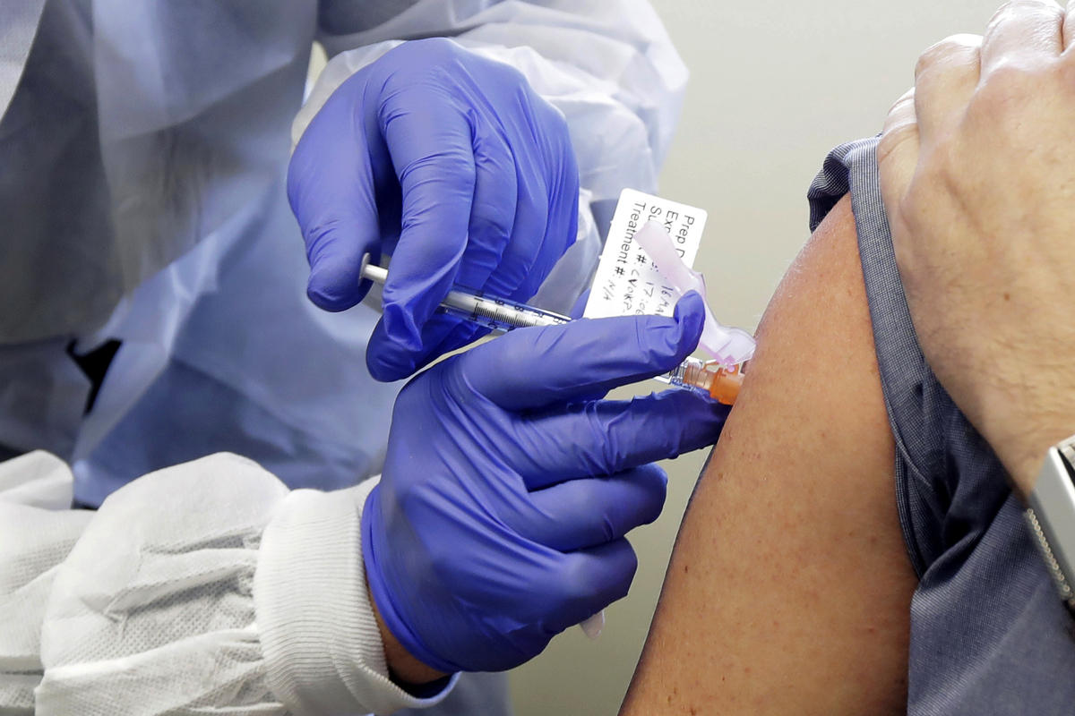 doctor injects patient with vaccine