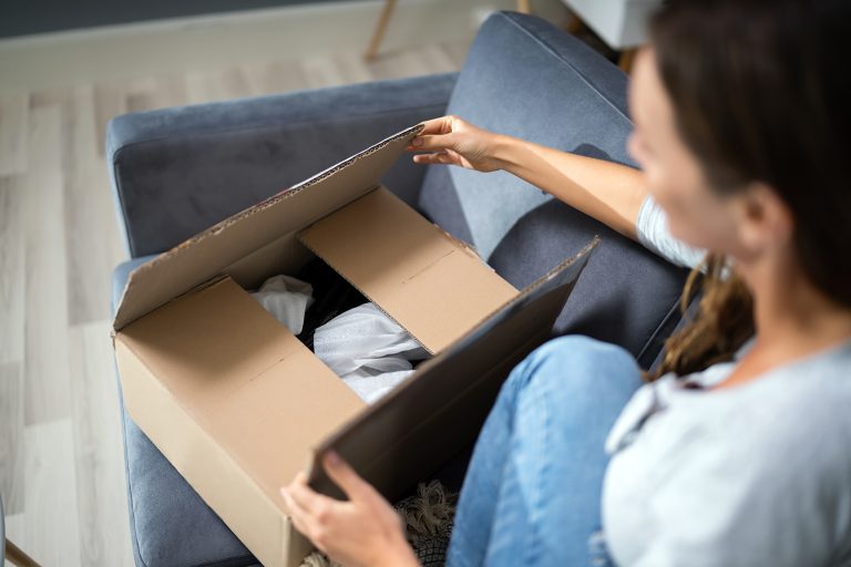 A woman opening a package she received in the mail