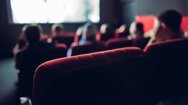 Audience members in a movie theater