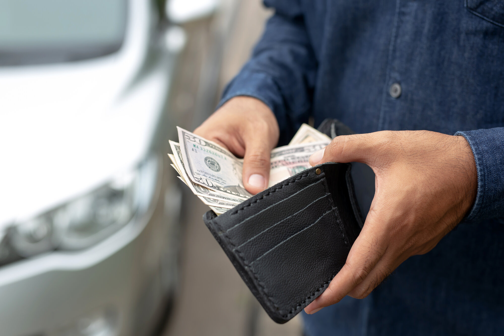 Man holding wallet with cash