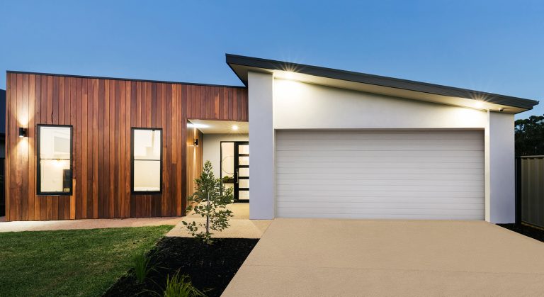 A modern house with a fancy garage door and impressive architecture