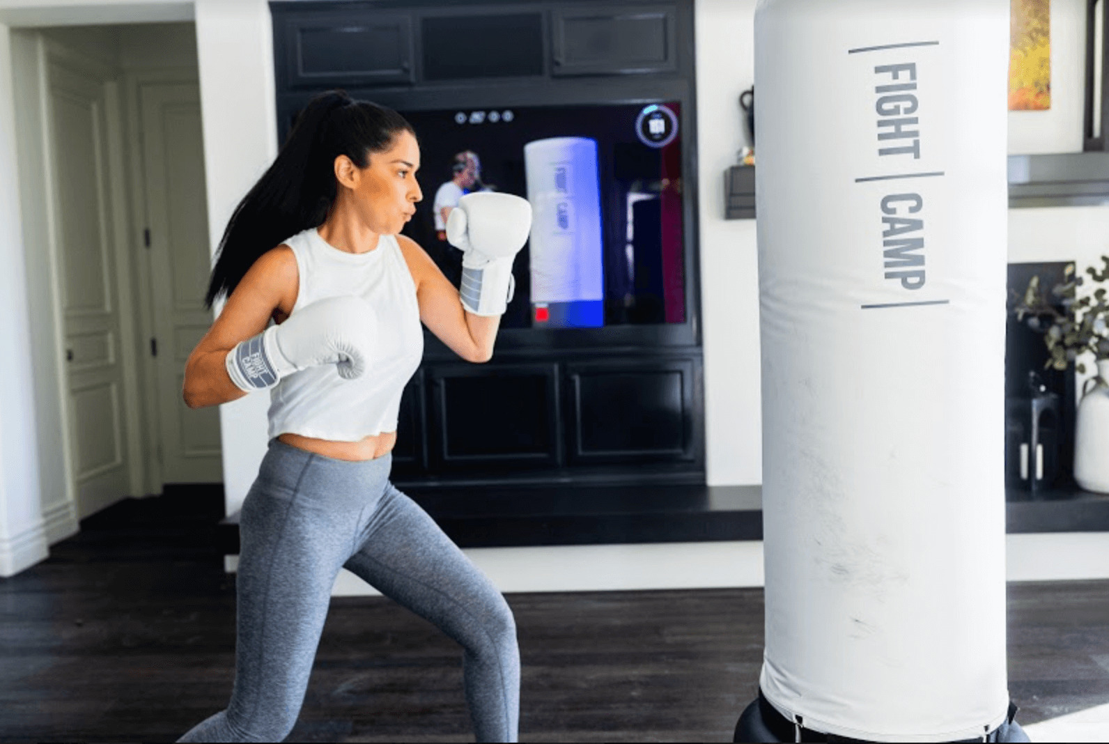 A woman following an interactive boxing training session