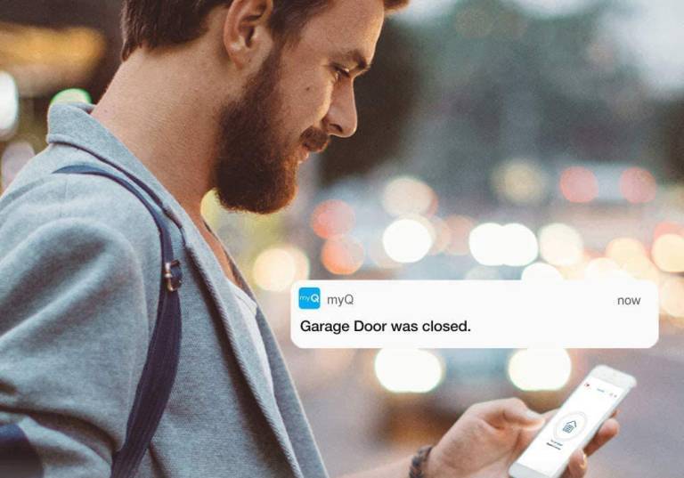 A man uses the MyQ app to close his garage door while commuting to work