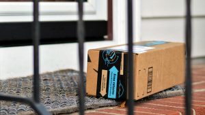 Amazon package at front door step on brick steps