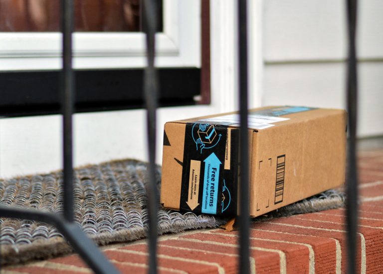 Amazon package at front door step on brick steps