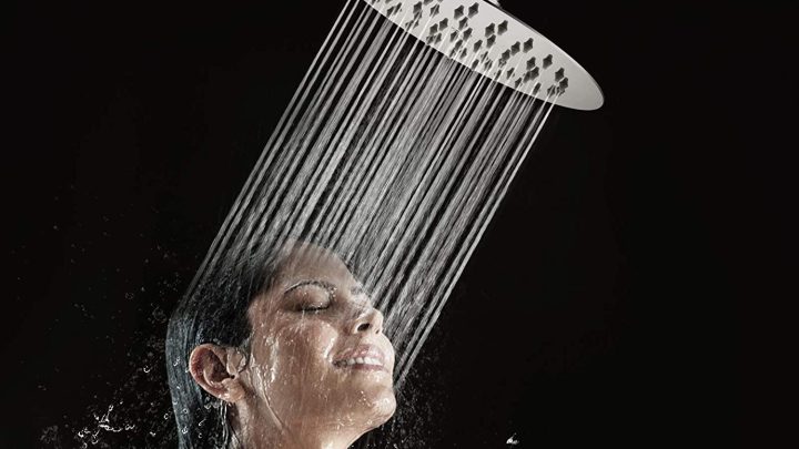 A woman showering with a rainfall shower head