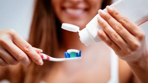 toothbrush viruses Woman Brushing Teeth