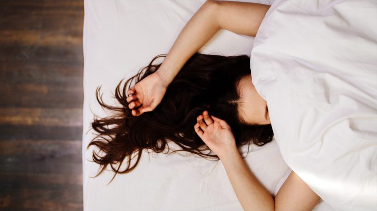 A woman sleeping comfortably in her bed