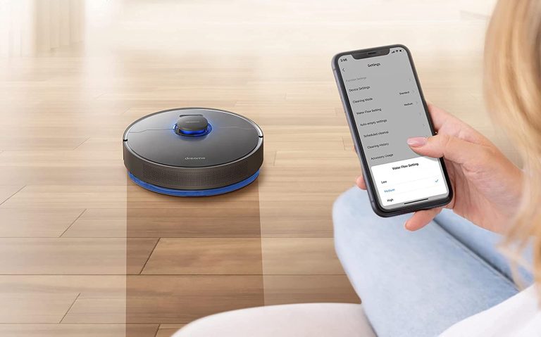 A woman controlling the Dreametech Z10 Pro robot vacuum with her smartphone