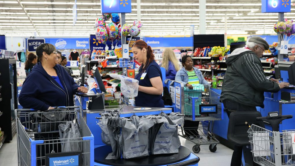 A Walmart cashier helping a customer