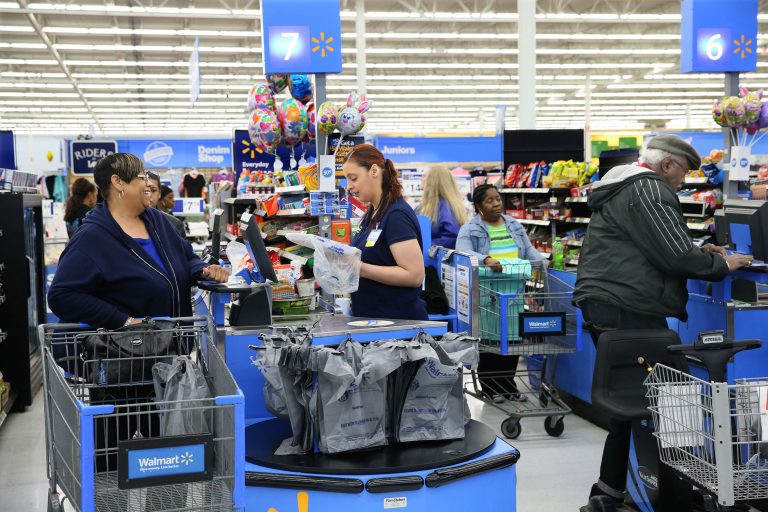 A Walmart cashier helping a customer