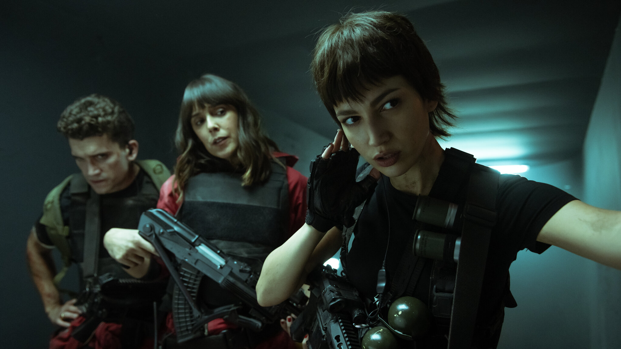 two dark haired women with guns