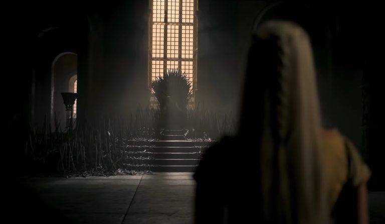 A woman with long blond hair admires the Iron Throne