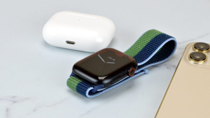 Apple Watch Series 7 on a table next to AirPods Pro and an iPhone 13 Pro