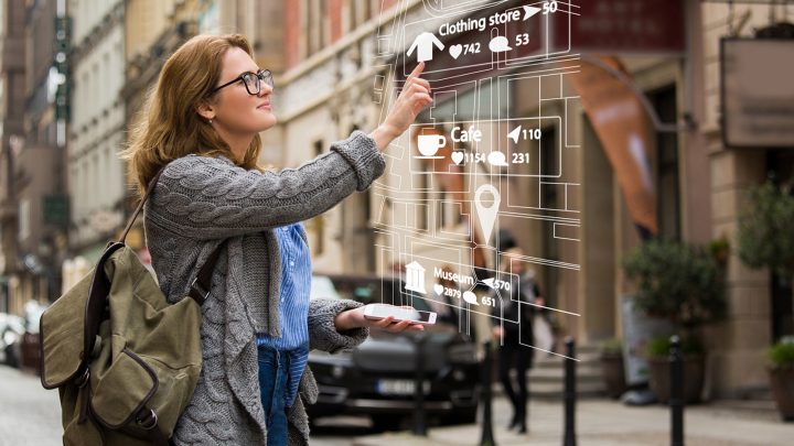 A woman uses the augmented reality features on her AR glasses