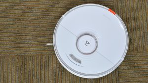 The Roborock S7+ robot vacuum cleaning the floor in a house