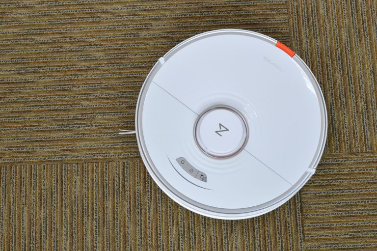 The Roborock S7+ robot vacuum cleaning the floor in a house