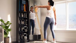 The NordicTrack VAULT mirror gym guiding a woman through a workout