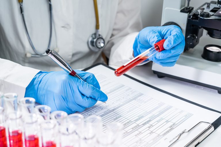 A scientist tests blood in a lab