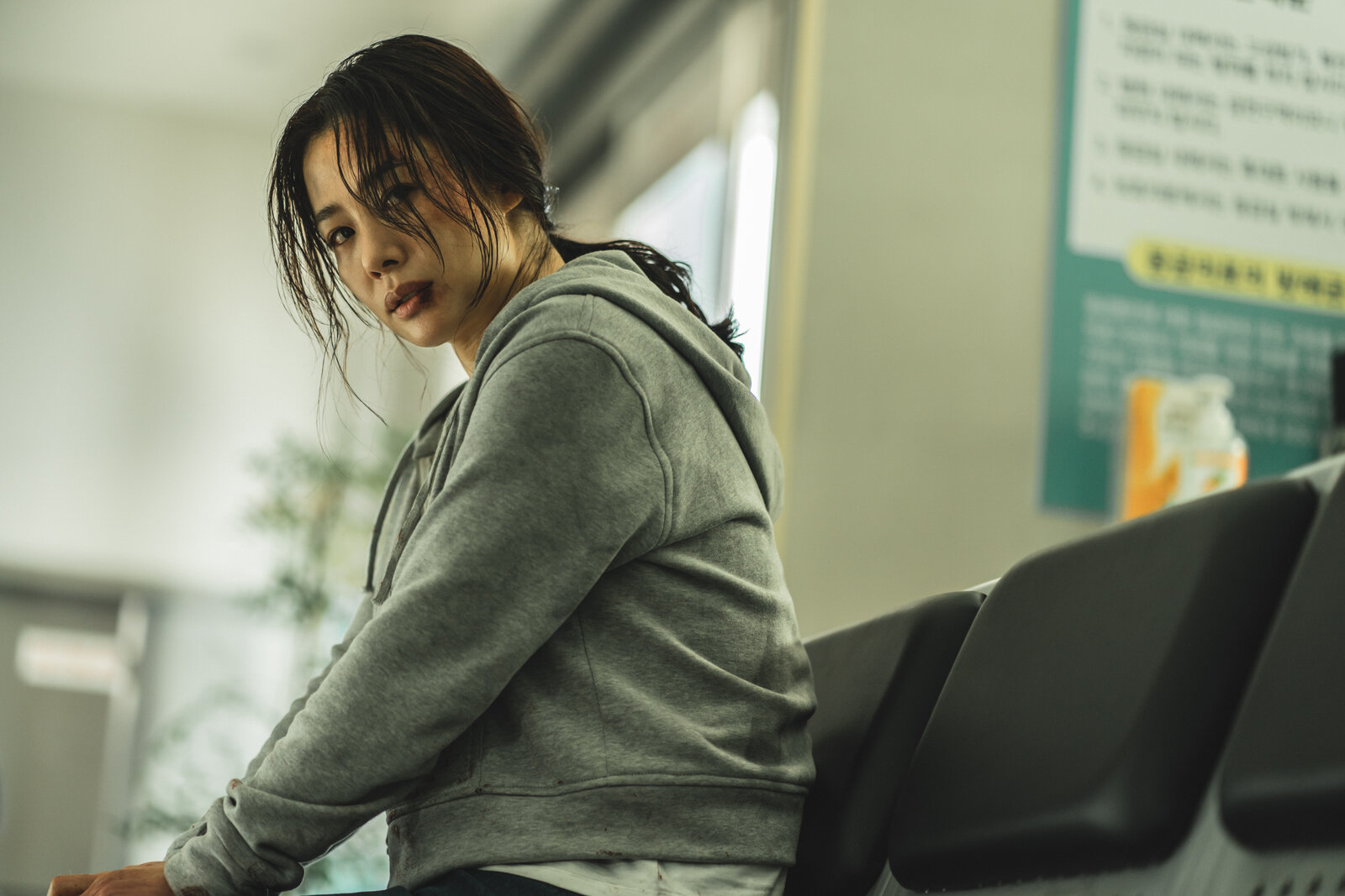 woman in grey shirt sitting on bench