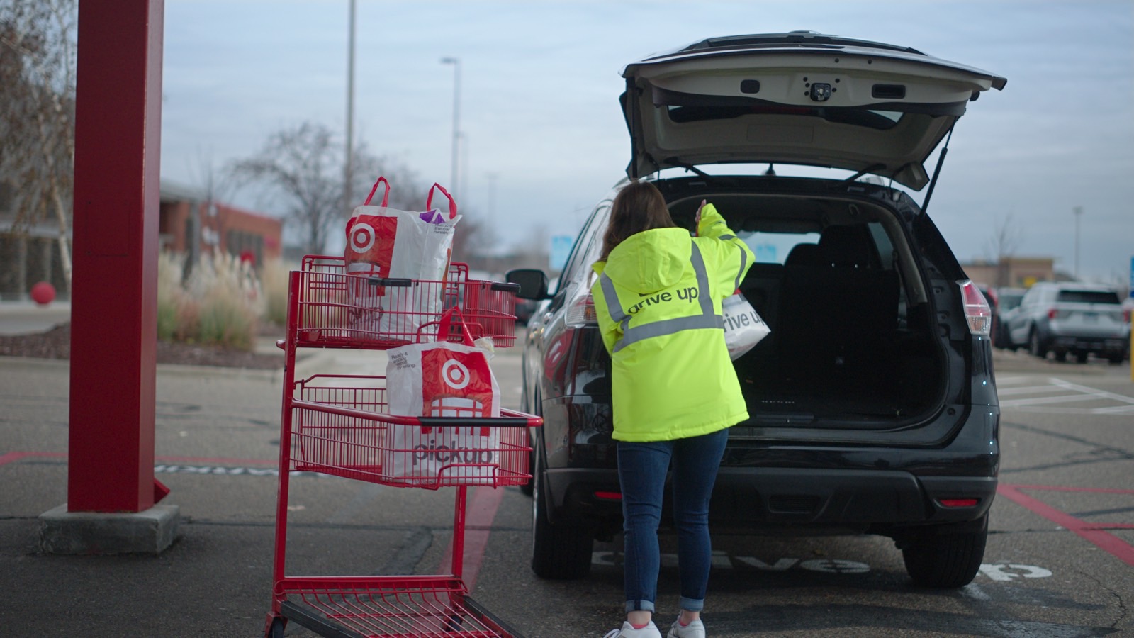 A person loading Target bags into a car