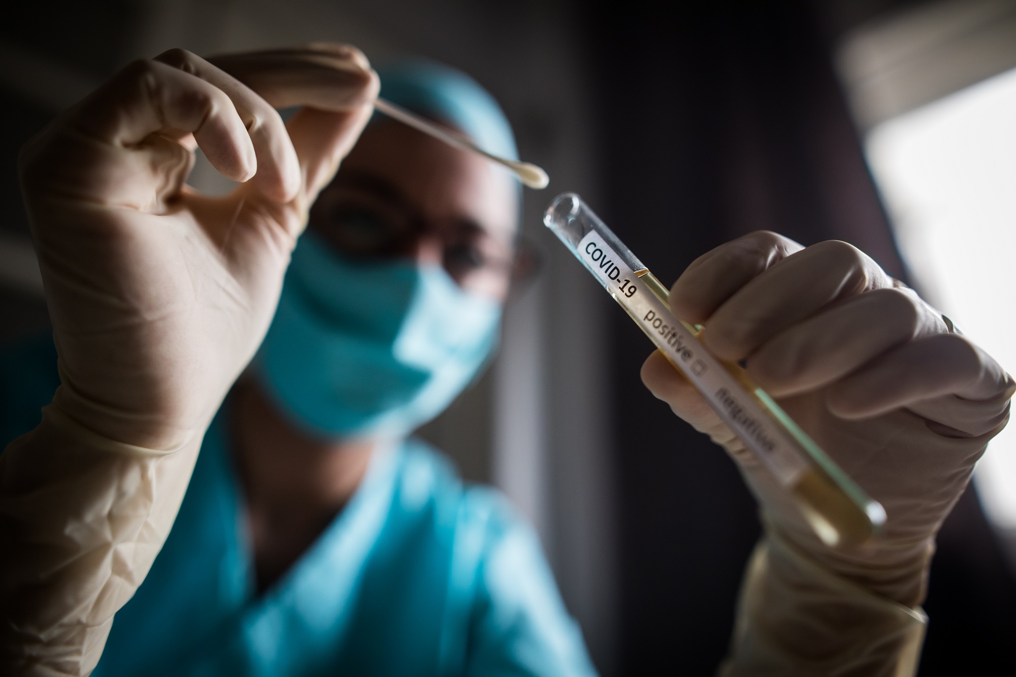 Doctor holding a coronavirus COVID-19 test tube