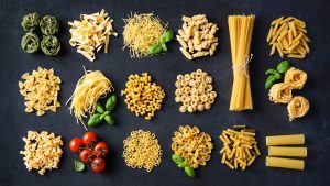Various pasta over stone background