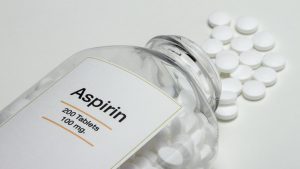 Aspirin bottle with pills spilling out