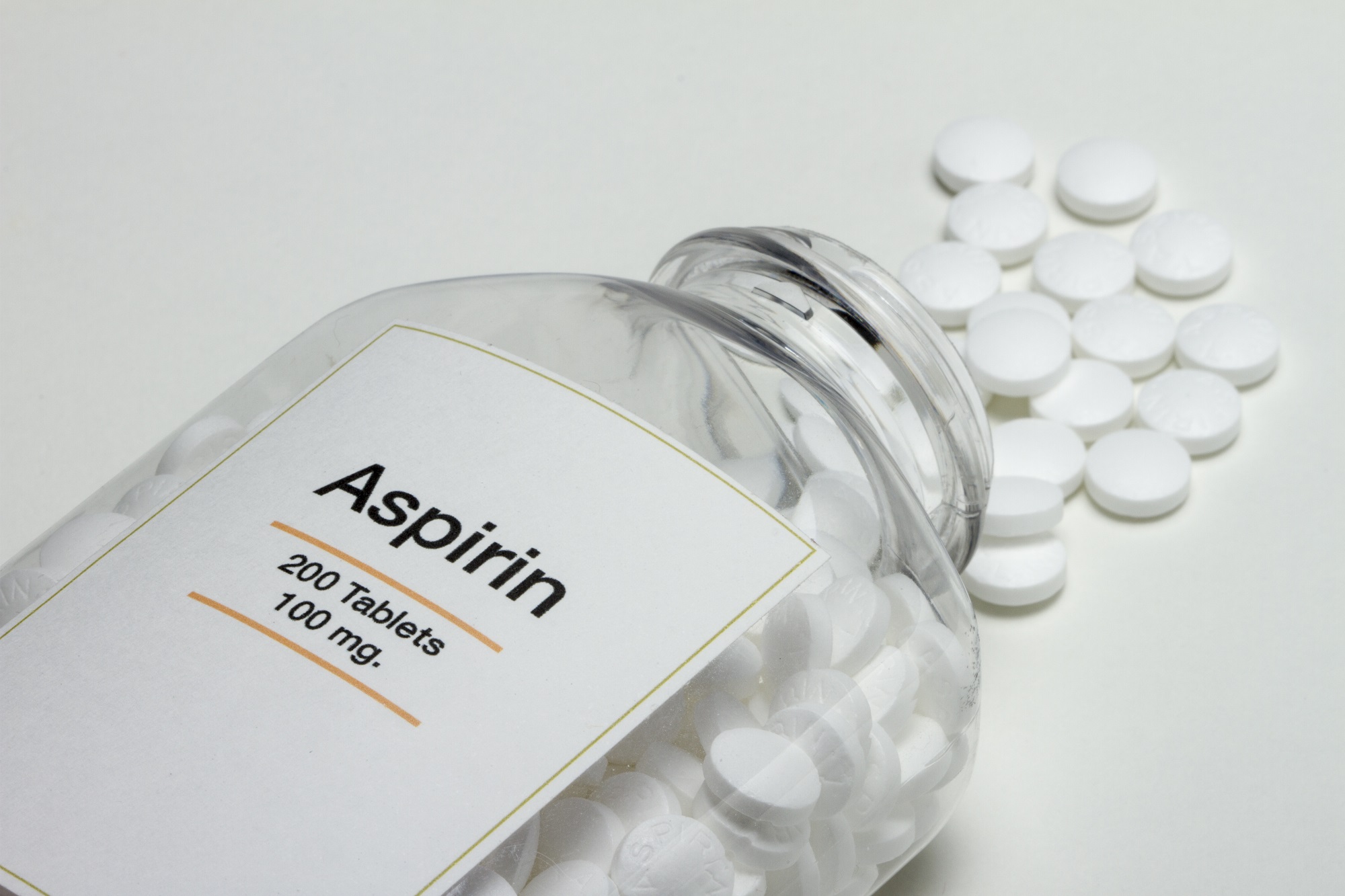 Aspirin bottle with pills spilling out