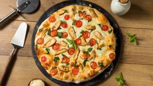 Homemade Chicken Alfredo Pizza with Tomato and Basil