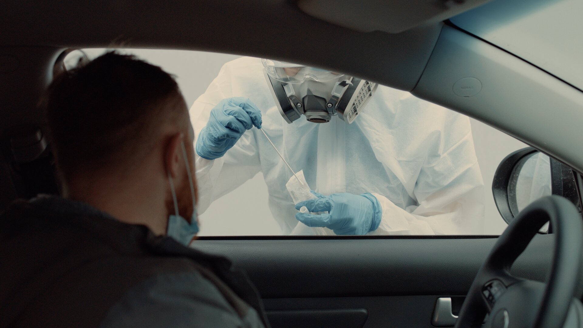 A patient is tested in his vehicle in a drive-through coronavirus COVID-19 testing location