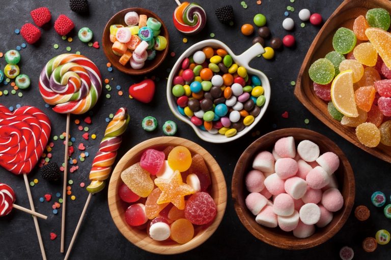 Colorful candies, jelly and marmalade on stone background