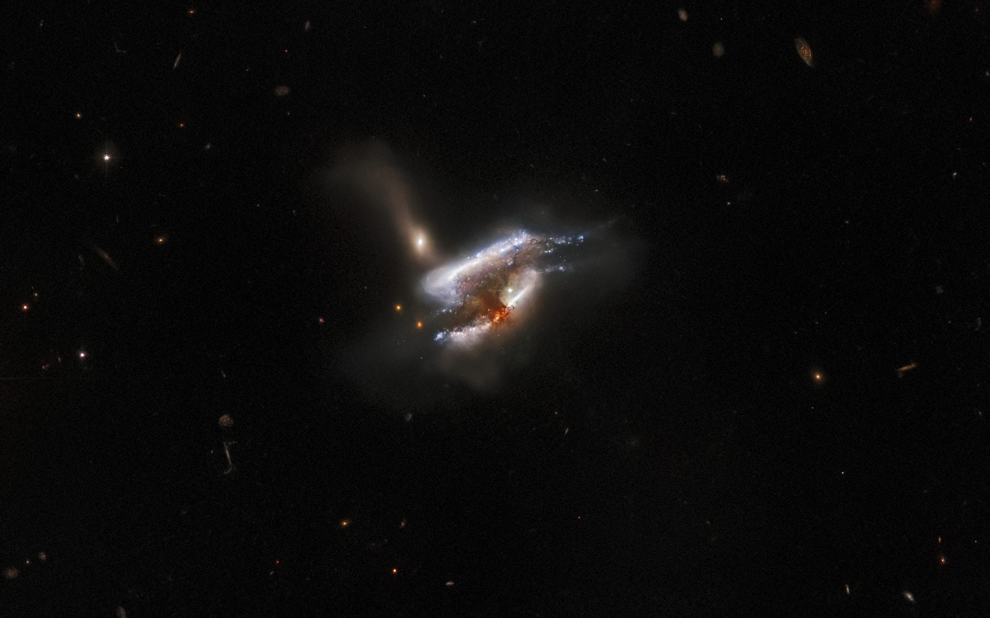 galaxies merging in a cloud of dust