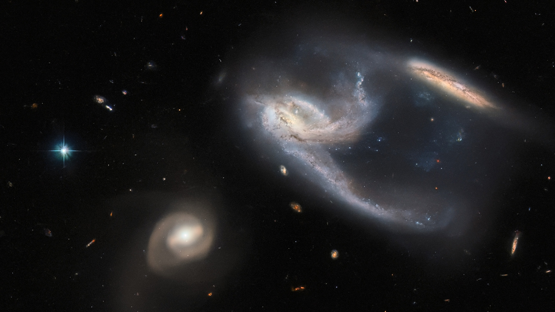 three galaxies interacting together in hubble telescope picture