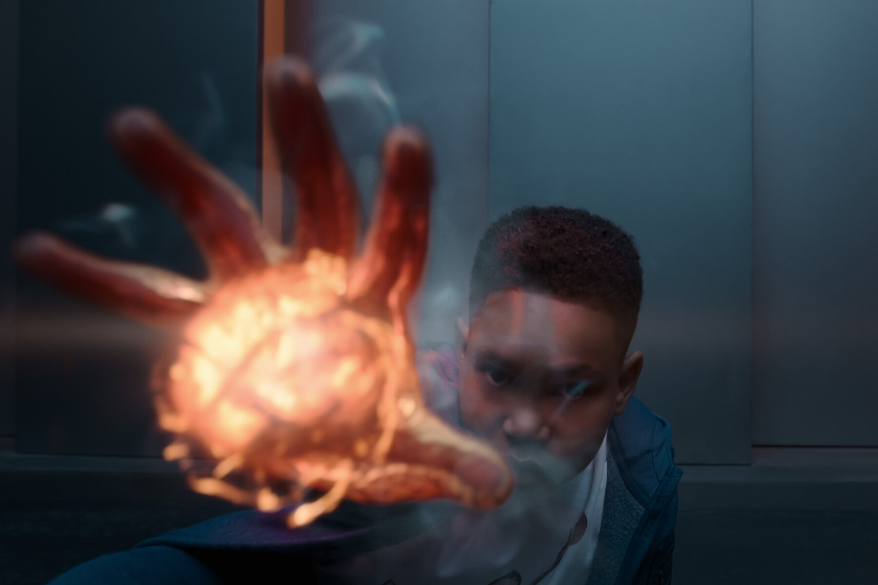 close up of a young boy's outstretched hand glowing