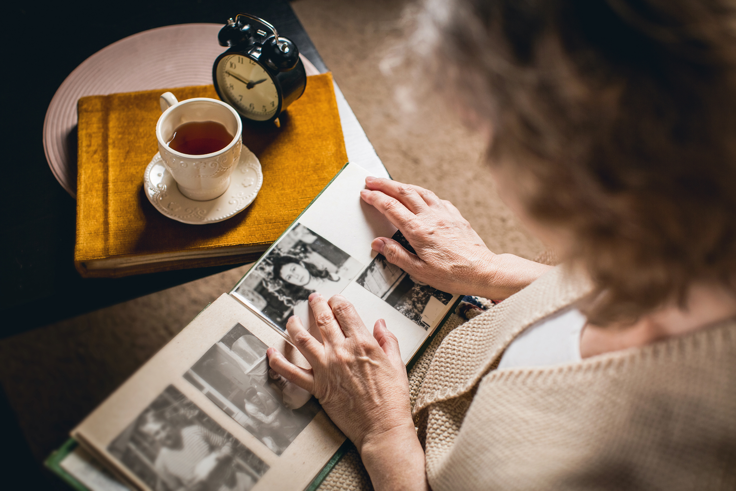 woman looks at old photo memories