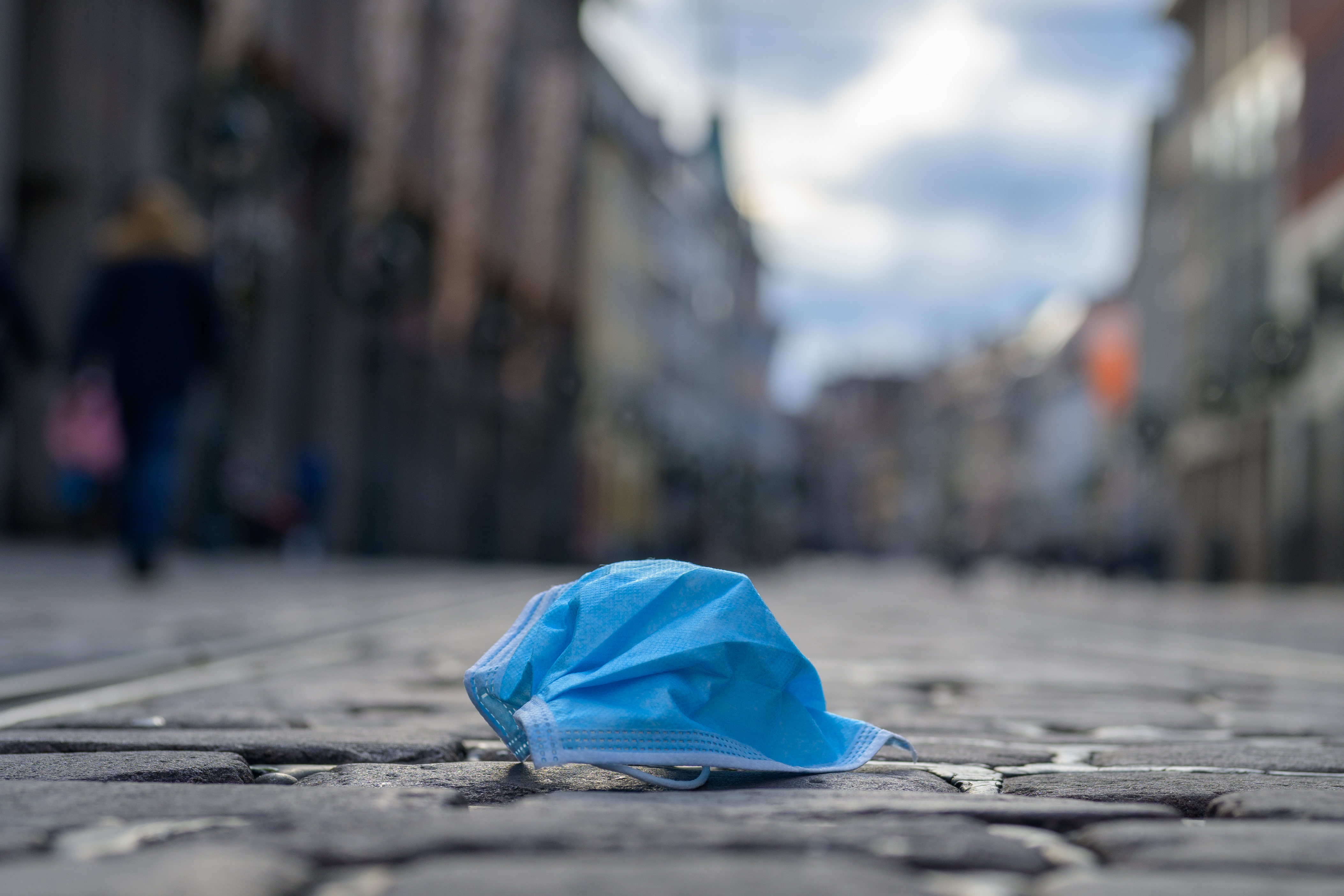 discarded face mask in city street