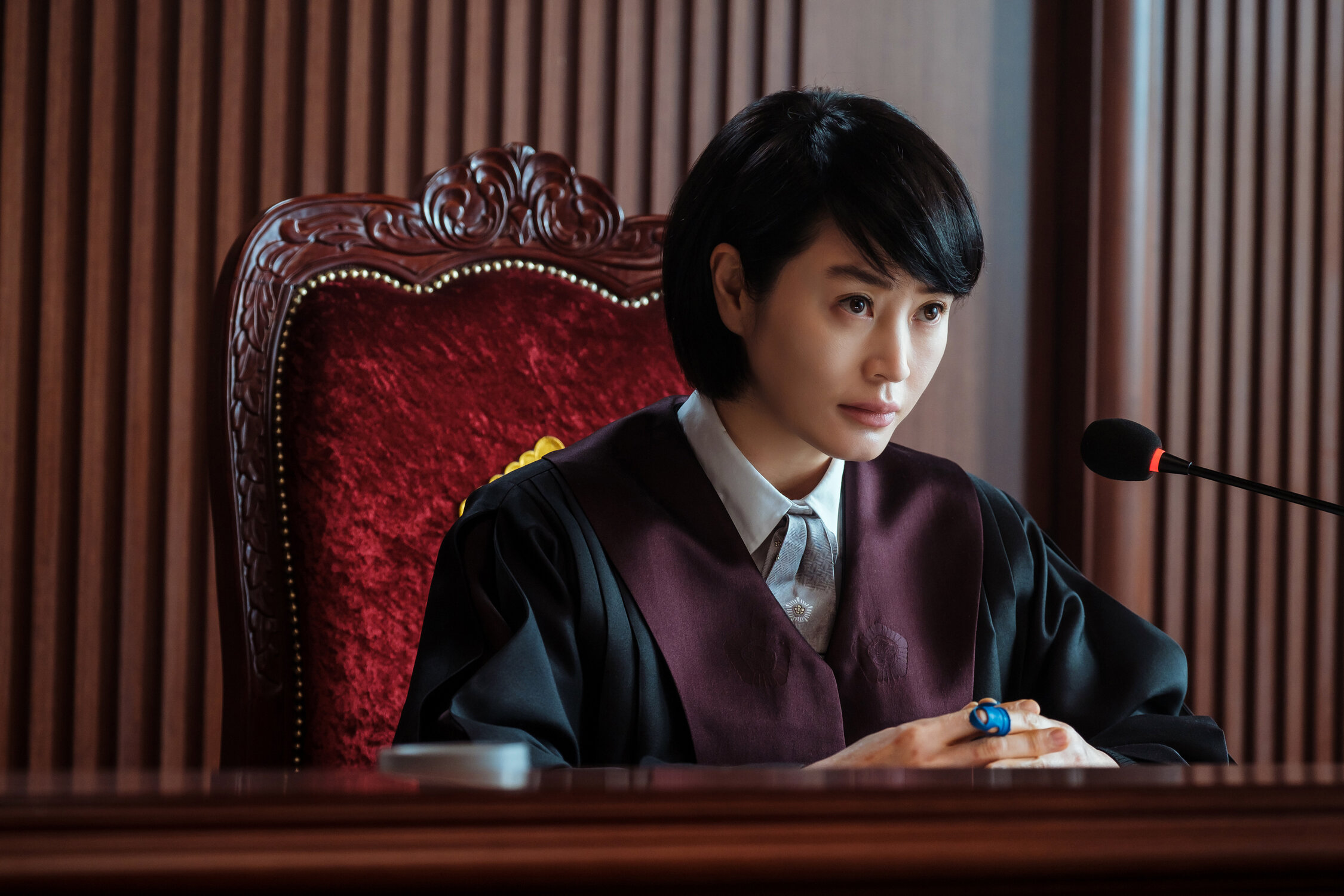 female judge seated in a black robe