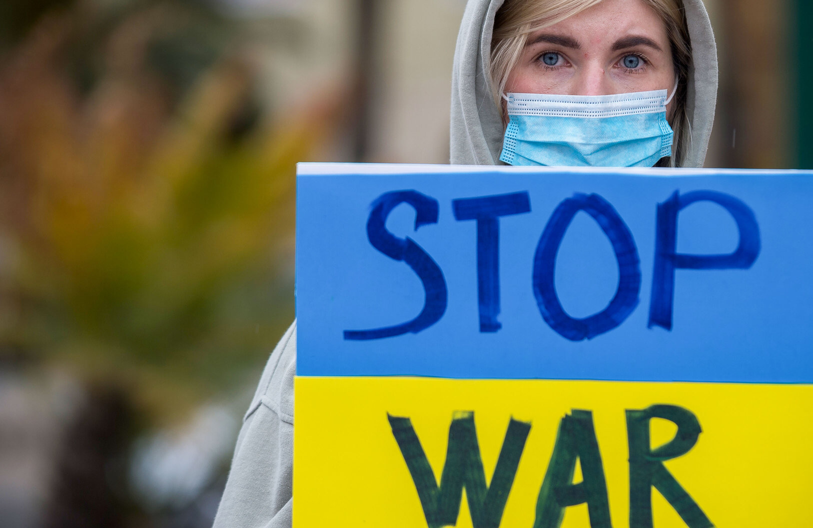 ukraine protestor holds stop war sign