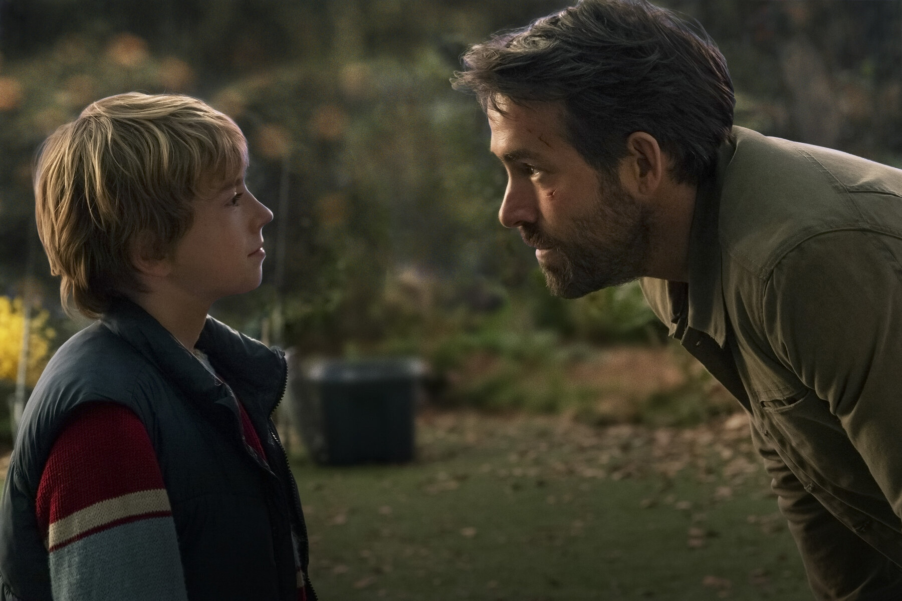 ryan reynolds talks to a young boy