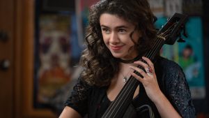 closeup of a young woman holding a musical instrument