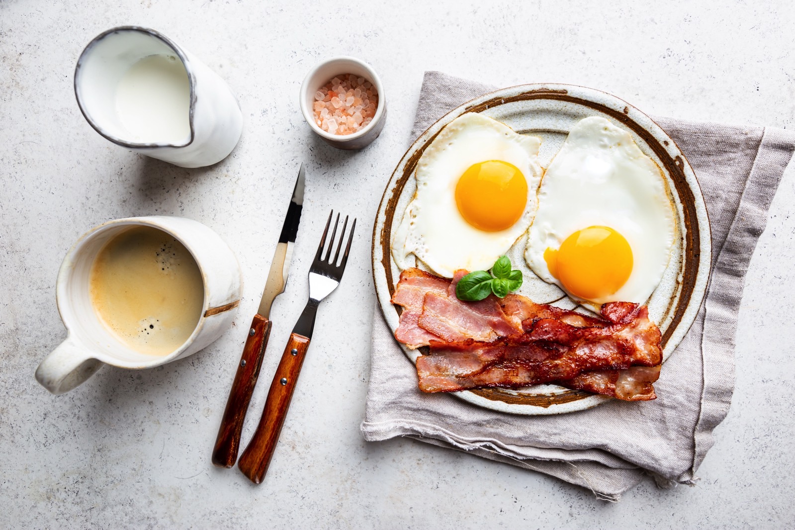 Fried eggs and bacon for breakfast on a plate.