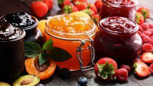 Fruit and jams on a table.