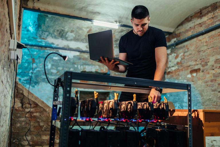 Shot of a young man checking a Cryptocoin mine