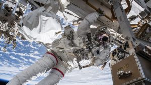 astronaut conducts ISS spacewalk