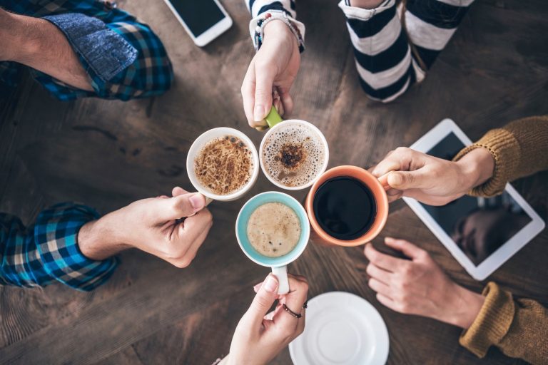 People drinking coffee from various types of cups.