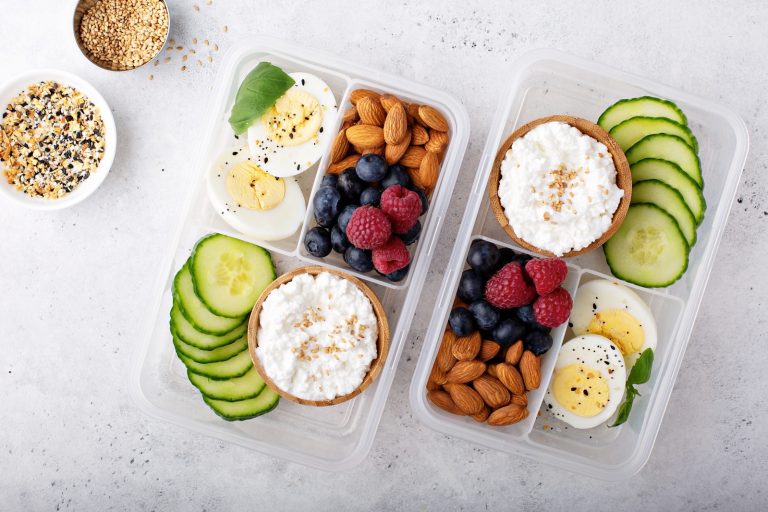 Lunch or snack box with high protein food, cottage cheese, nuts and eggs.